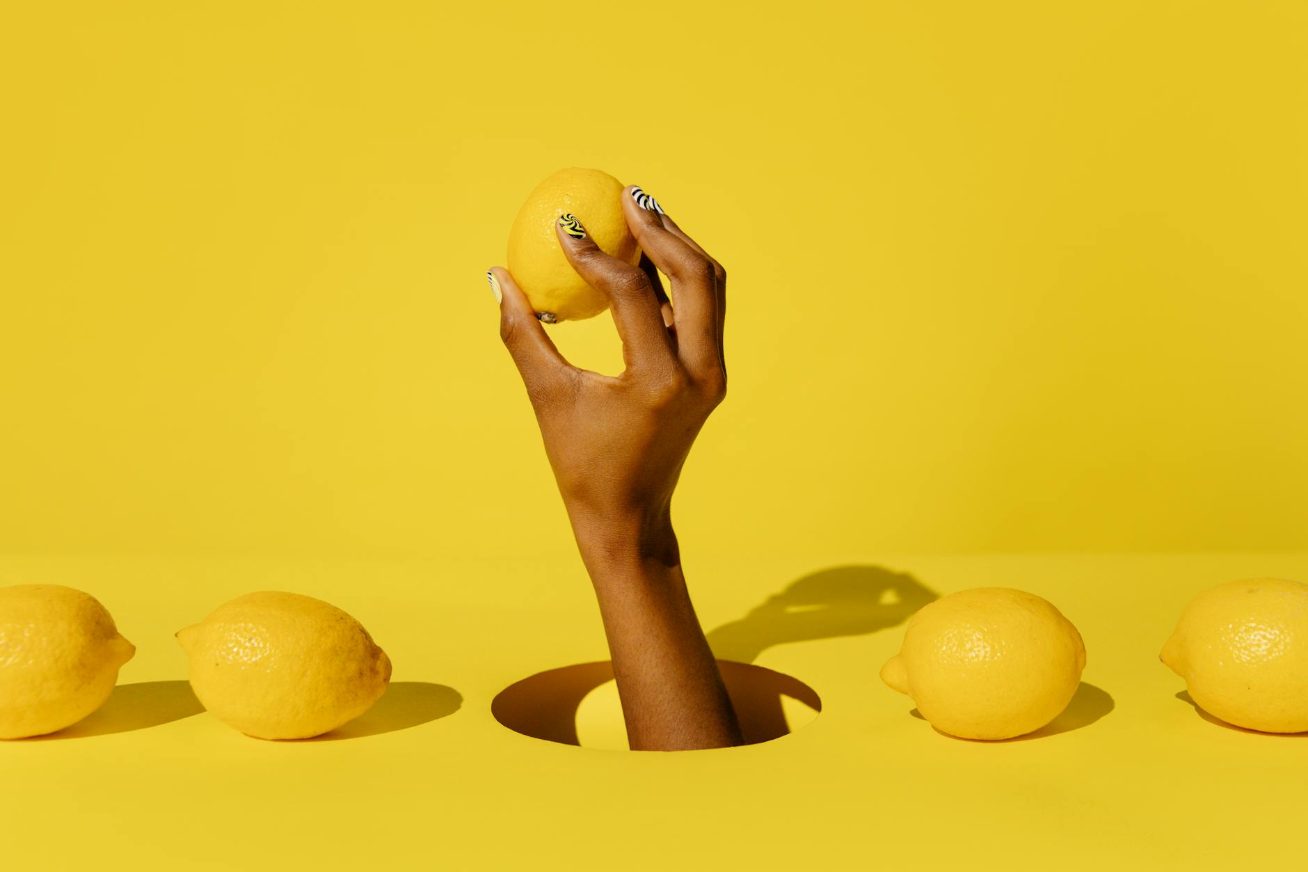 Yellow silicone vibrator surrounded by peeled bananas on bright yellow background