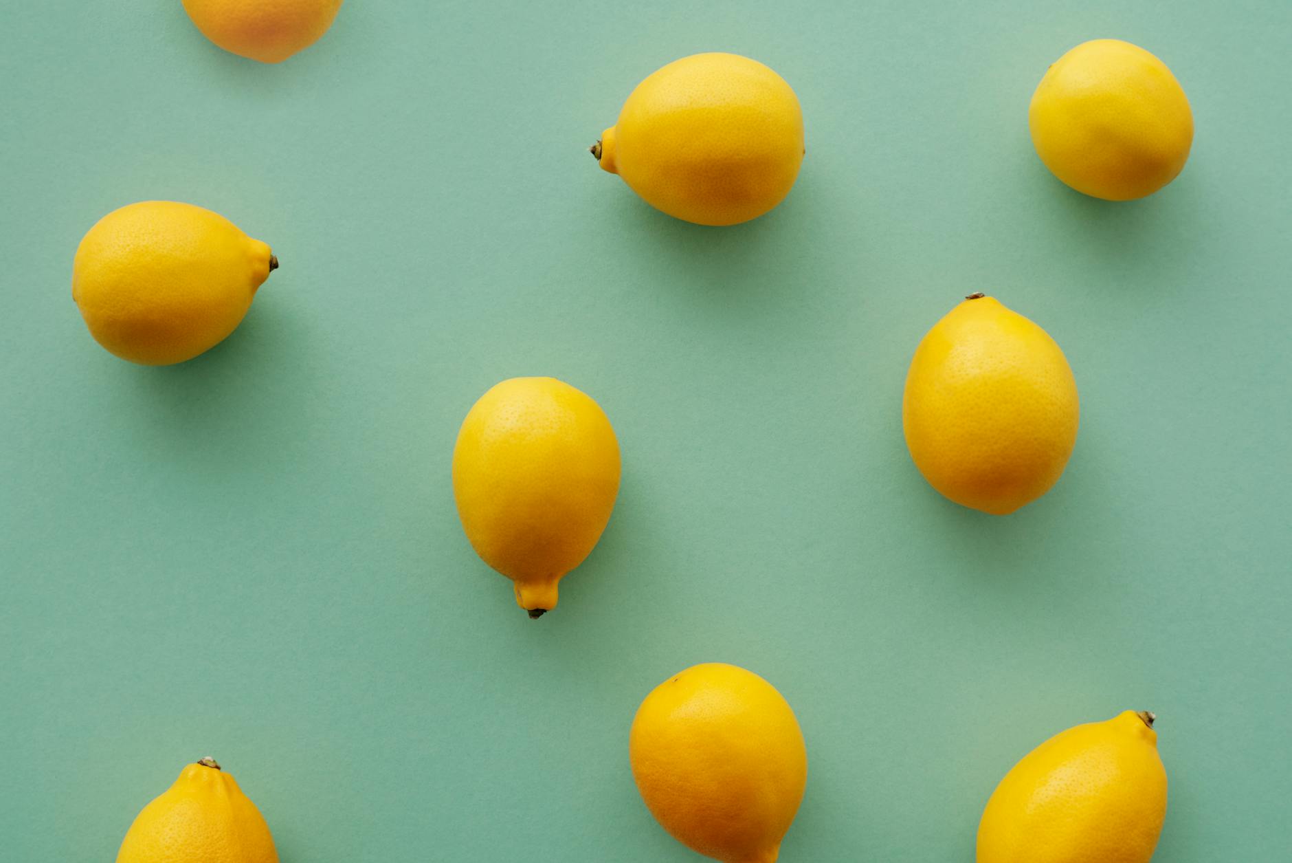 Bright yellow lemons arranged on a pastel green background, symbolizing the fresh, friction-free sensation of suction stimulation