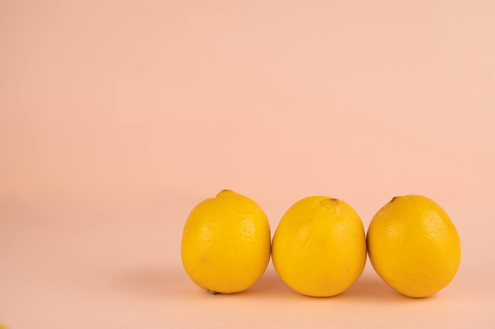 Bright ripe lemons arranged on a pastel background, symbolizing the gentle return of sensuality